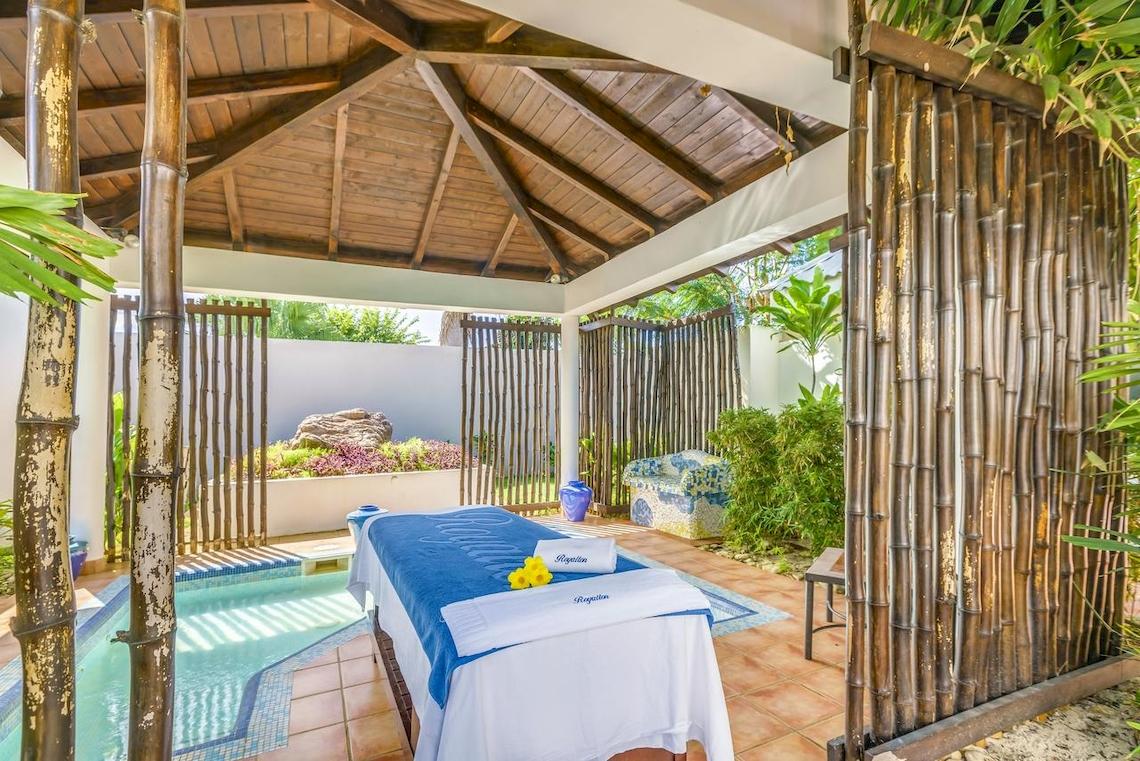 Massagebereich im Freien im Royalton Hicacos Resort & Spa mit Pool und Bambuswänden.