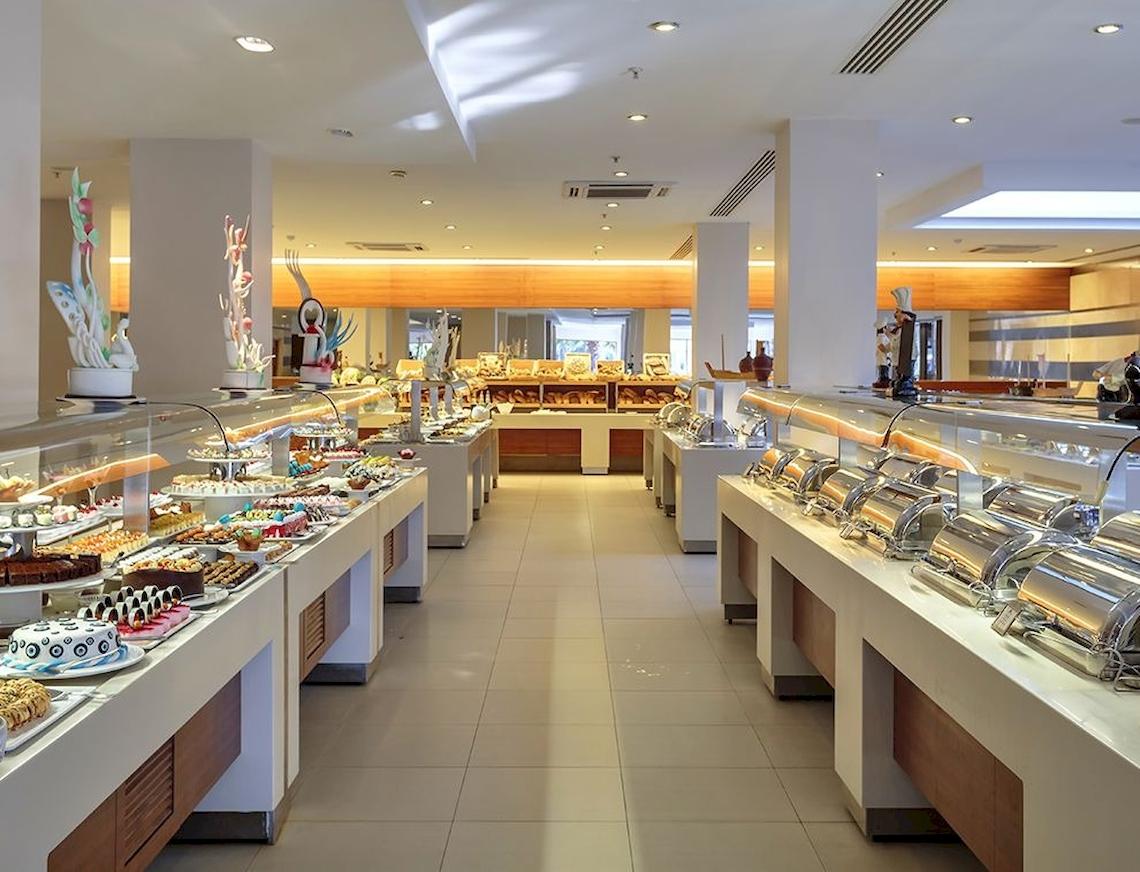 Buffet im Innenrestaurant des Sunis Elita Beach Resort Hotel & Spa mit verschiedenen Kuchen und Desserts.