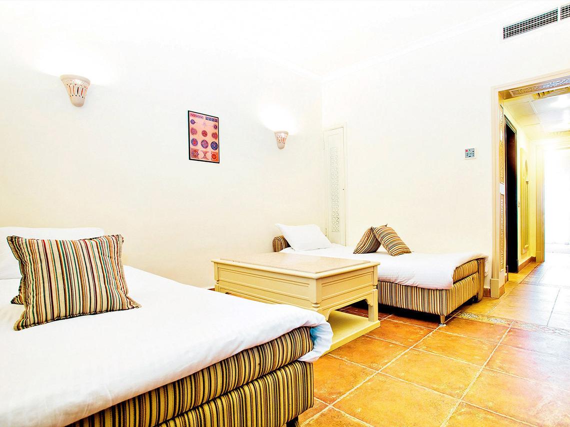 Zwei Zimmer im Sentido Mamlouk Palace Hotel mit einem Doppelbett und einem Einzelbett.