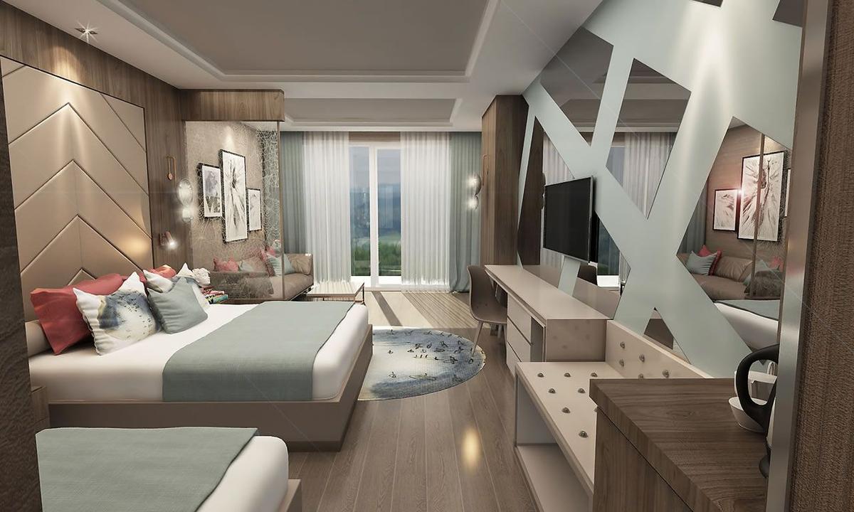 Innenansicht eines Hotelzimmers im Delphin BE Grand Resort mit zwei Betten, Fernseher und geometrischen Wänden.