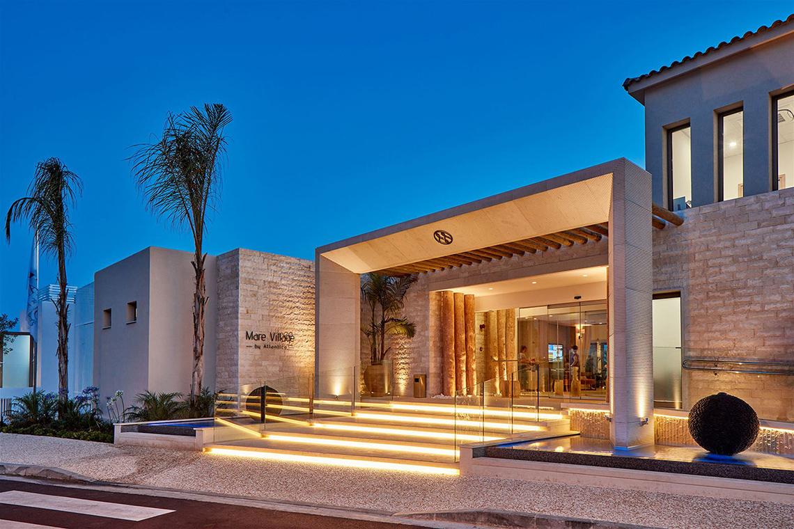 Außenansicht des Mare Village Hotel in Ayia Napa bei Nacht mit beleuchteter Treppe und Eingang.