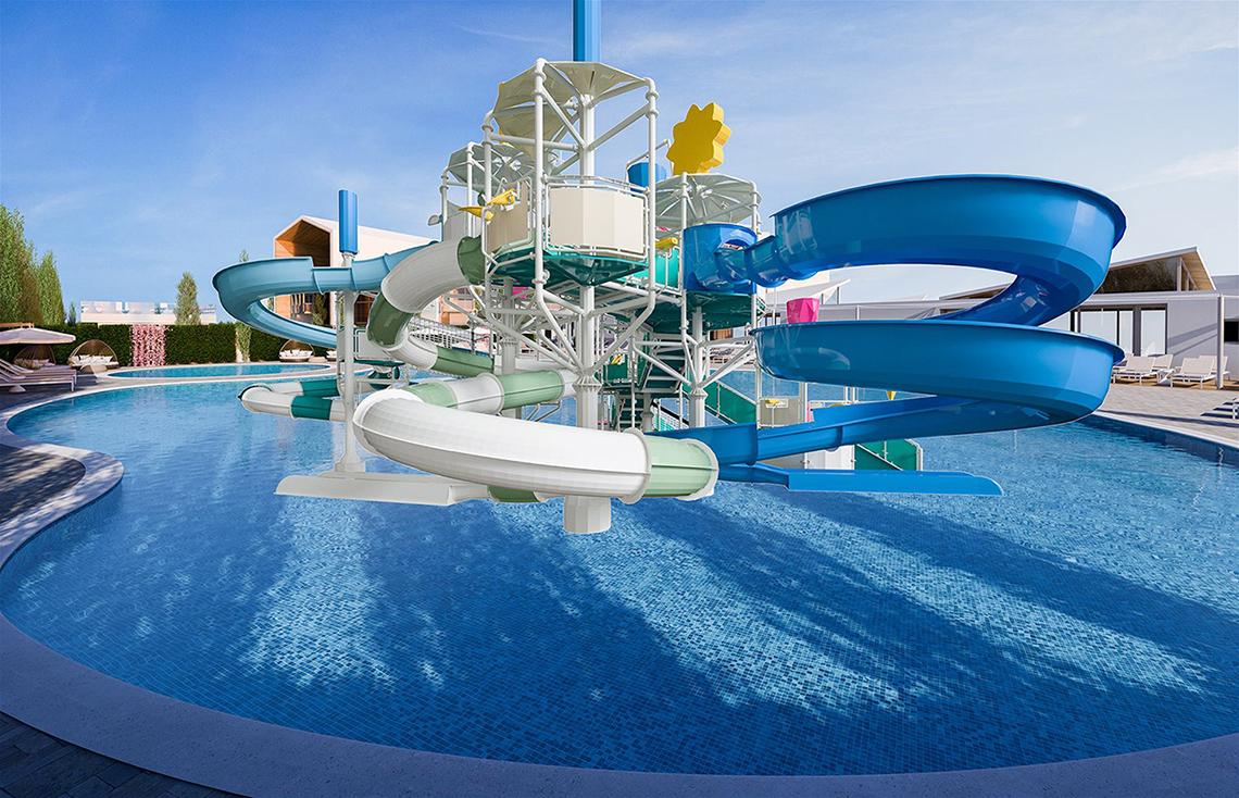 Wasserrutsche im Schwimmbad des Mare Ayia Napa Hotels, umgeben von Liegestühlen und Pflanzen.
