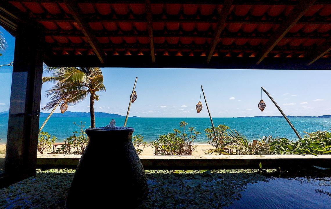 Aussicht von der Terrasse des Saree Samui Resorts auf einen Strand mit Palmen und Wasser