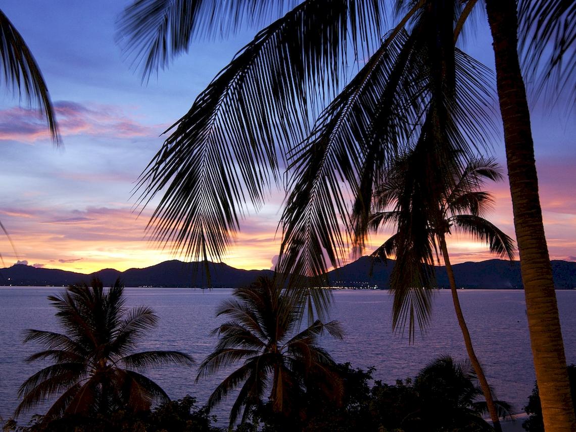 Sonnenuntergang über dem Pullman Phuket Panwa Beach Resort mit Blick auf das Meer und die Berge.
