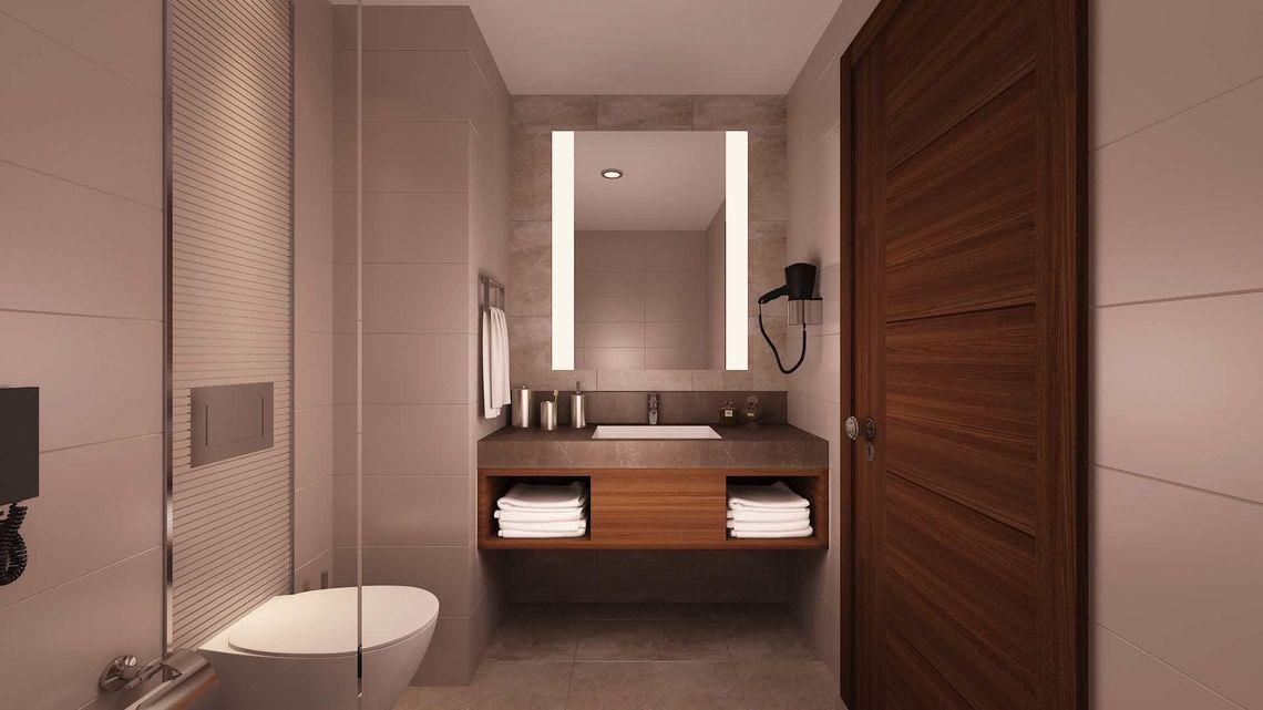 Badezimmer im Side Sunport Hotel & Spa mit Spiegel, Waschbecken und Toilette.