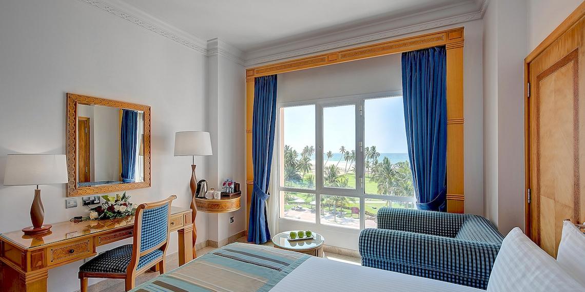 Innenansicht eines Hotelzimmers im Crowne Plaza Resort Salalah mit Blick auf das Meer.
