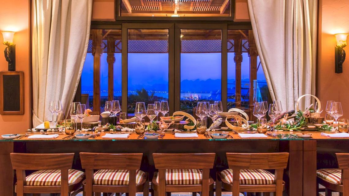 Innenansicht des Esstisches im Kempinski Hotel Soma Bay mit Blick auf die Stadt und den Ozean.