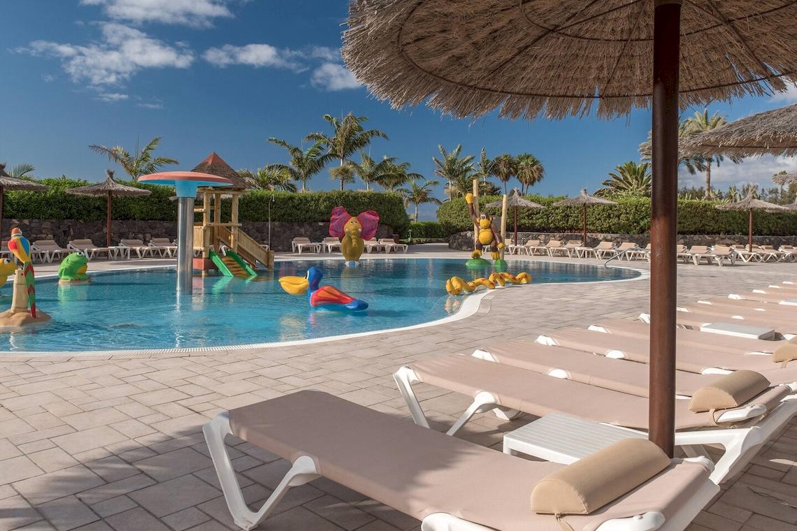 Poolbereich des Sheraton Fuerteventura Beach, Golf & Spa Resorts mit Liegestühlen und bunten Wasserspielzeug.