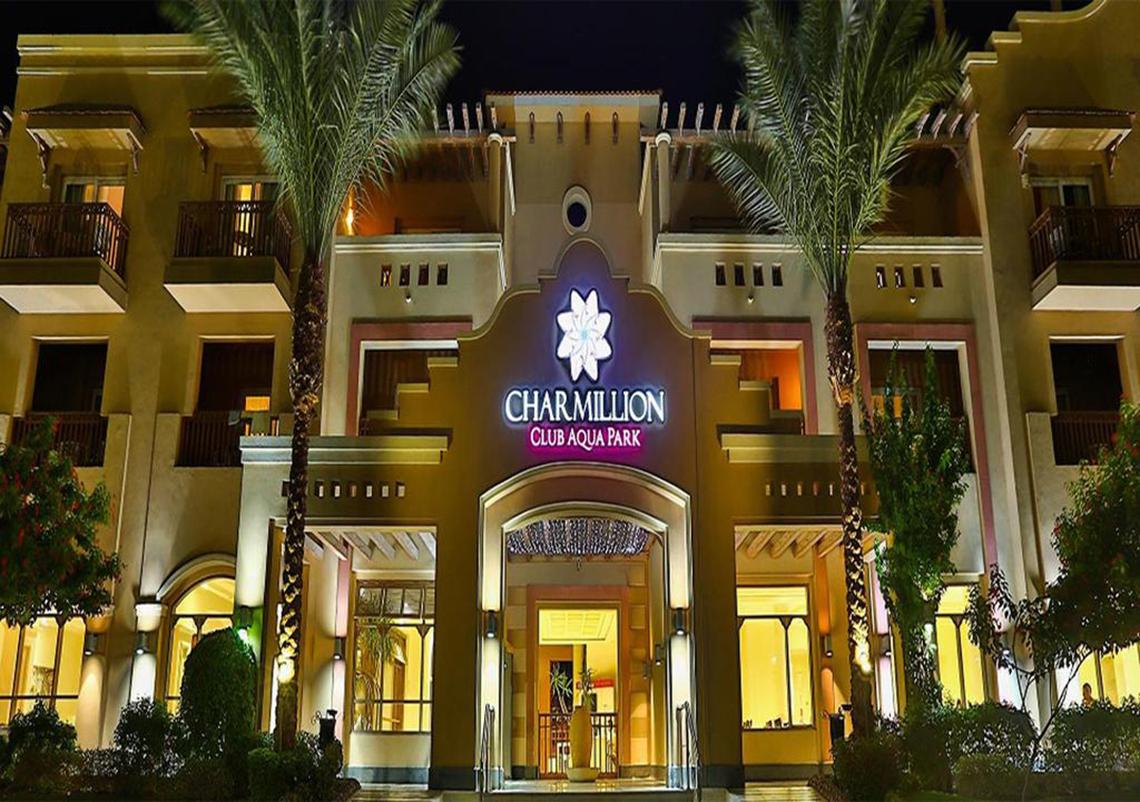 Charmillion Club Aqua Park Hoteleingang bei Nacht mit Palmen und Beleuchtung