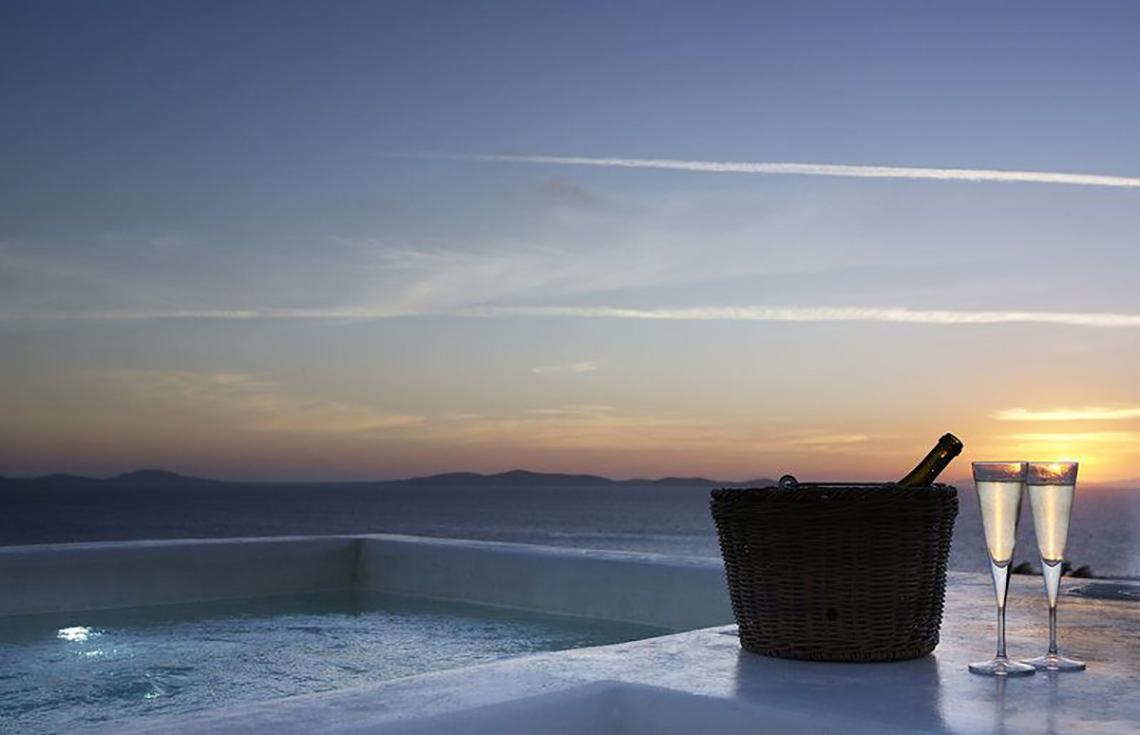 Terrasse des Rocabella Mykonos Art Hotel & Spa mit Blick auf den Sonnenuntergang.