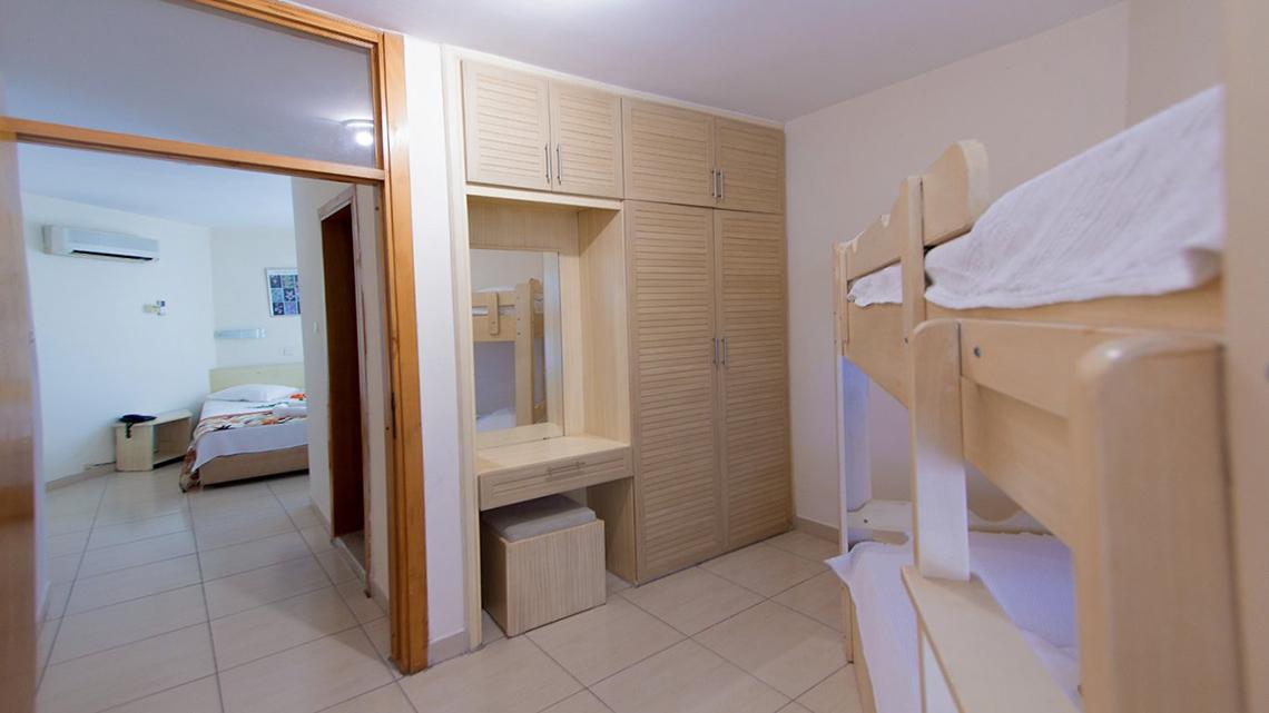 Schlafzimmer mit Stockbetten im Malhun Hotel, das durch eine Tür zugänglich ist.