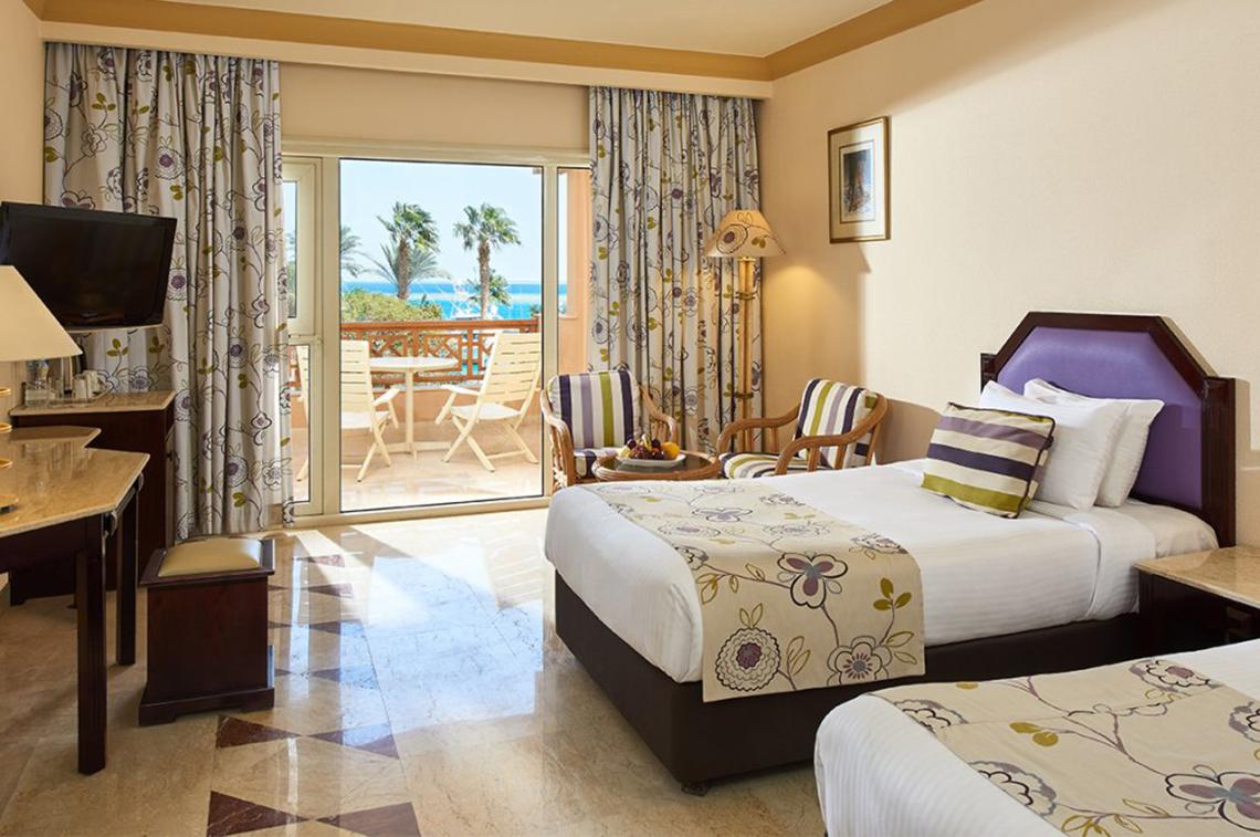 Doppelzimmer im Continental Hotel Hurghada mit Blick auf den Balkon und das Meer.