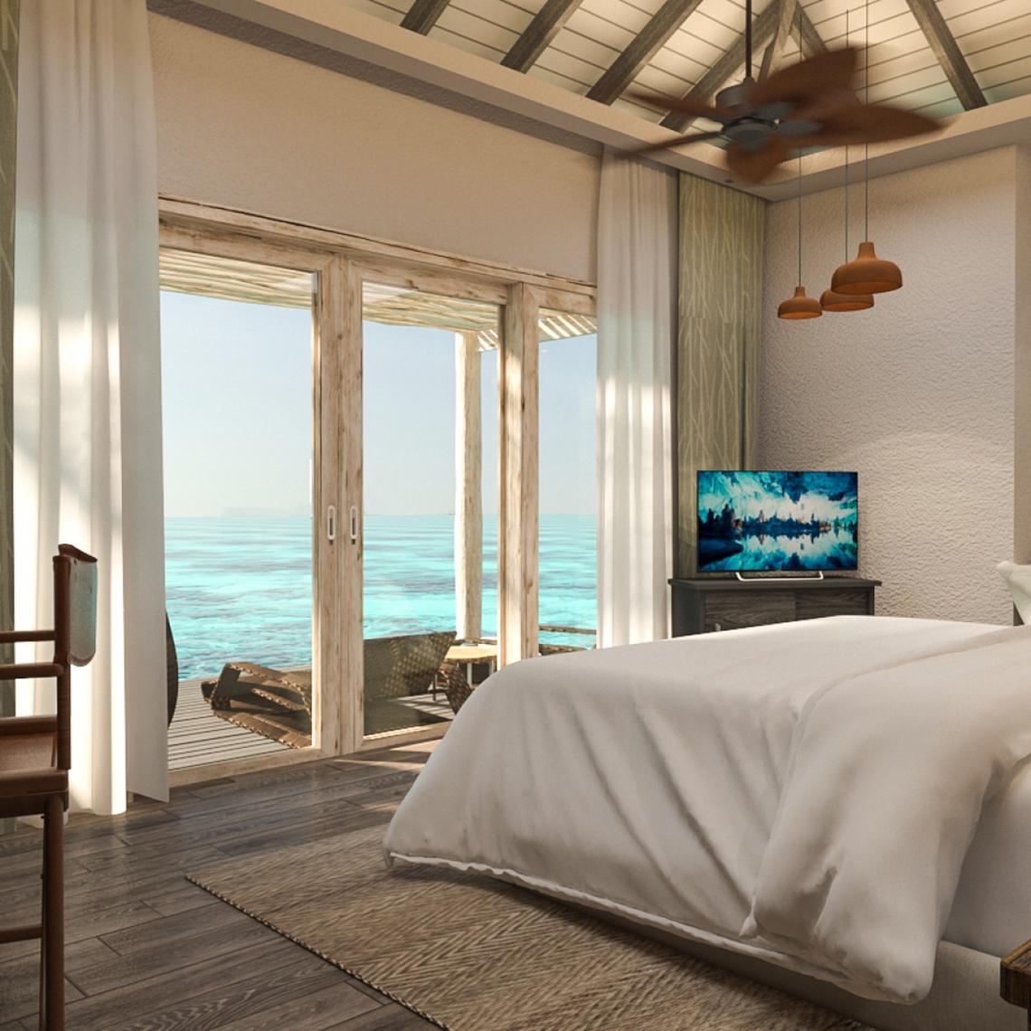 Schlafzimmer mit Meerblick im You & Me Maldives Hotel mit offenem Balkon und Fernseher.