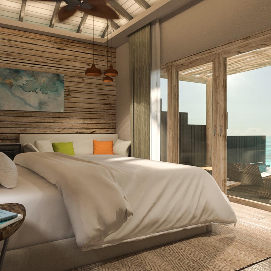 Schlafzimmer mit Meerblick im You & Me Maldives Hotel mit Holzwänden, Bett und Fenstern.