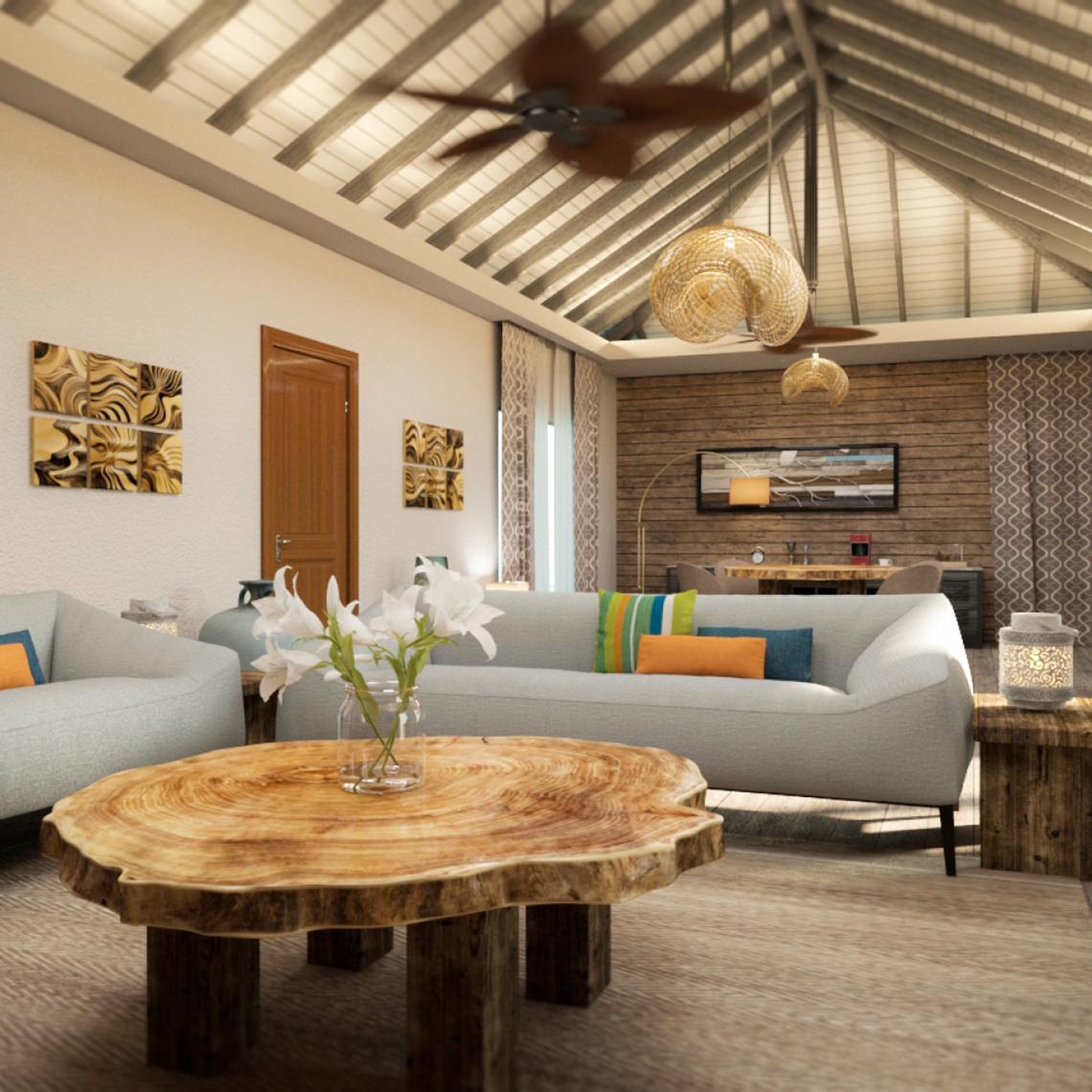 Wohnzimmer von You & Me Maldives mit Couch, Tisch und Dekoration.