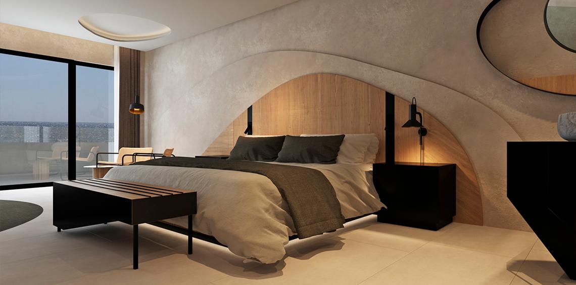 Hotelzimmer mit Bett, Nachttischen und Ausblick auf den Ozean