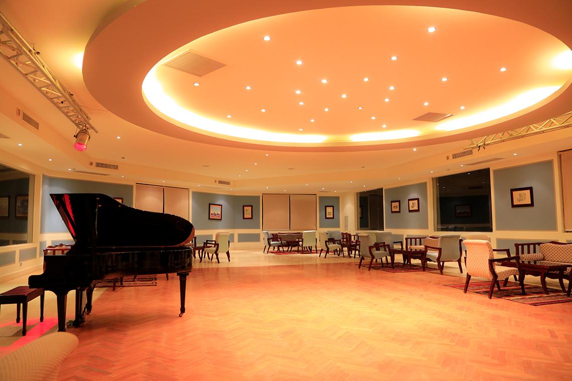 Piano-Lounge im Sharm Club Beach Resort mit einem schwarzen Klavier und gemütlichen Sitzgelegenheiten.