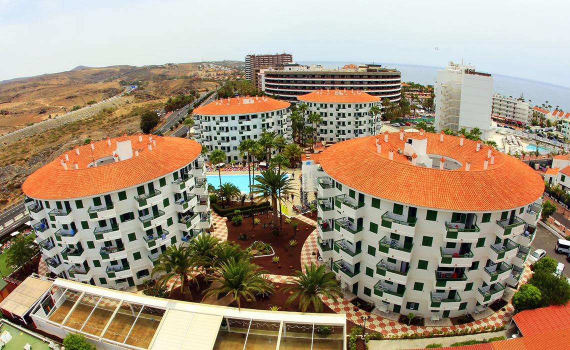 Servatur Playa Bonita Hotel with orange roofs and palm trees