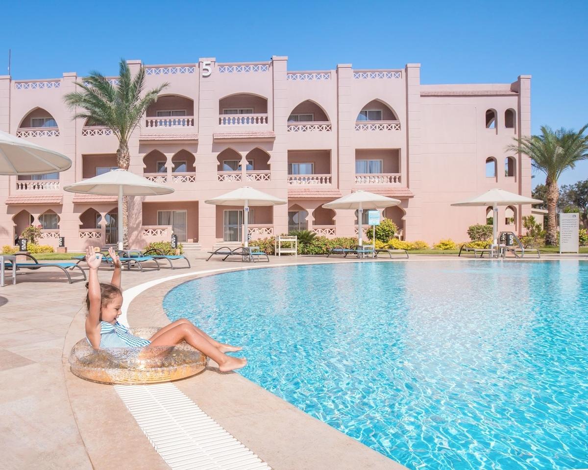 Ein Kind sitzt im Pool des Pickalbatros Aqua Vista Resorts.