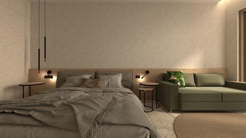 Modernes Schlafzimmerdesign im Alexandra Beach Resort mit Bett, Couch, Nachttischen und Teppich.