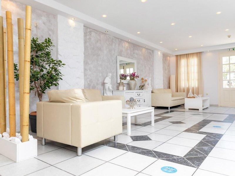 Innenbereich des Golden Coast Hotels mit weißen Möbeln und schwarzen und weißen Fliesenboden.