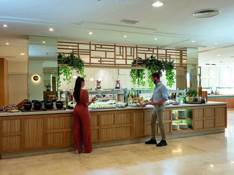 Buffet-Restaurant im Allsun Hotel Sumba mit zwei Gästen und Speisenauswahl.