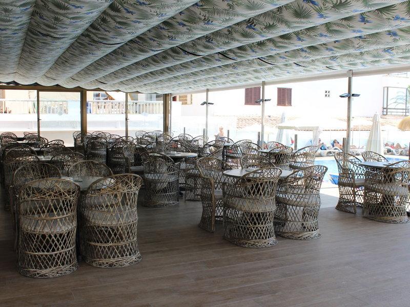 Innenbereich des R2 Veronica Beach Hotels mit Tisch und Stühlen.