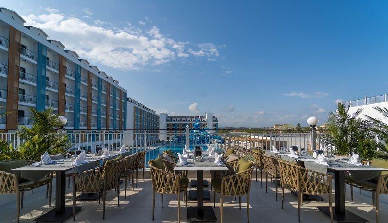 Außenterrasse des Arcanus Hotels Trendline Side mit Blick auf das Schwimmbad und die Hotelgebäude.