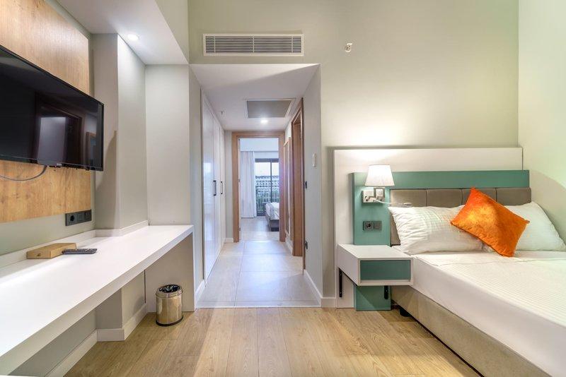Hotelzimmer im Arcanus Hotels Trendline Side mit Fernseher, Schreibtisch und Bett.