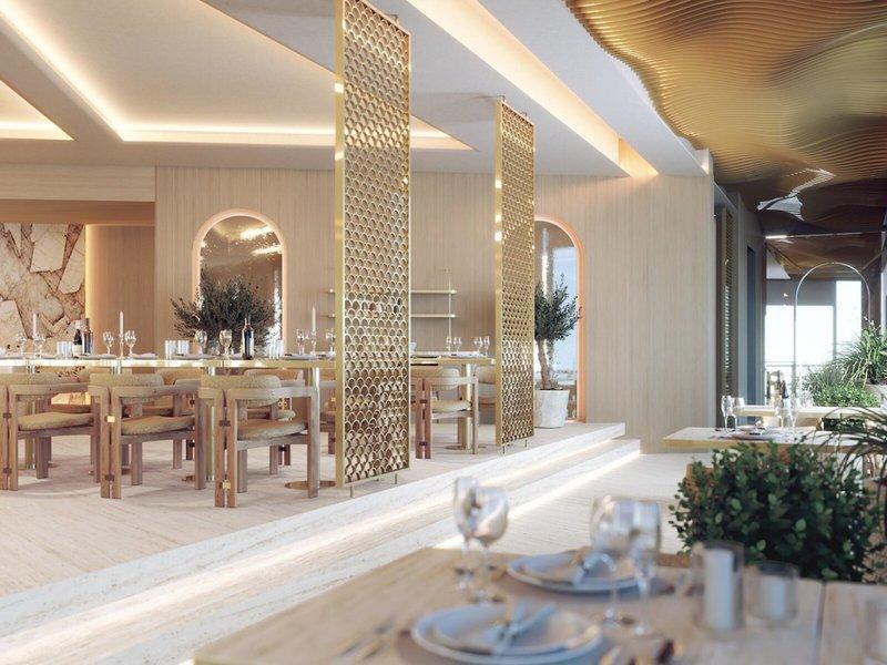 Interieur des Sheraton Doha Resort Convention Hotel mit goldfarbenen Trennwänden und runden Fenstern.