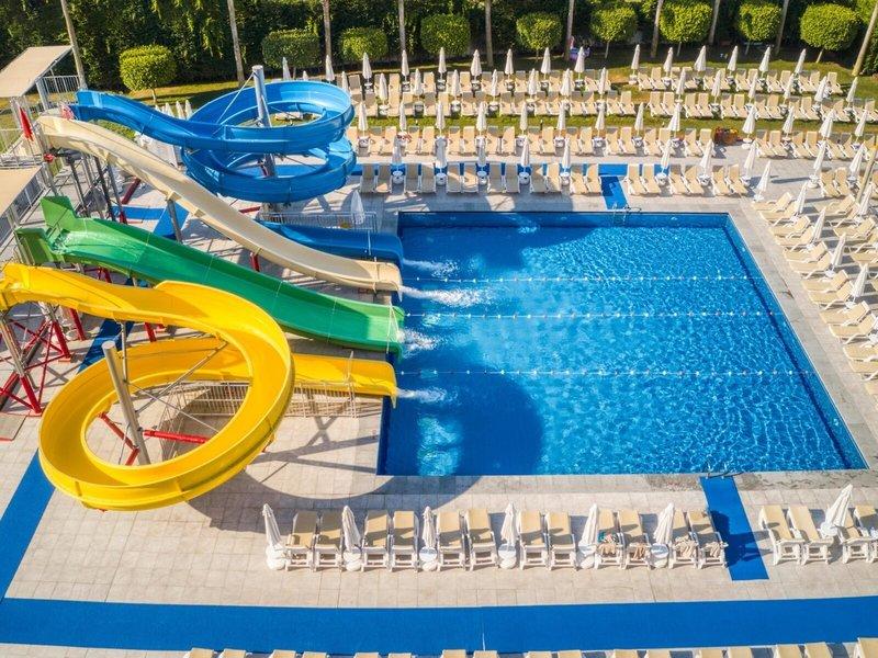 Luftaufnahme des Wasserrutschenbereichs im Grand Park Lara Hotel mit mehreren Rutschen und einem großen Pool.