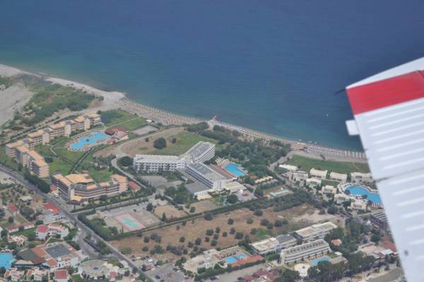 Luftaufnahme des Irene Palace Beach Resorts mit Blick auf die Küste und mehrere Gebäude, darunter Pools.