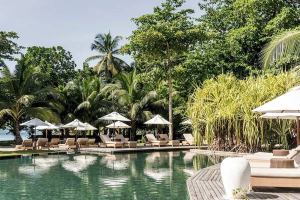 Constance Ephelia Resort Pool und Lounges mit Sonnenschirmen und Blick auf den Strand