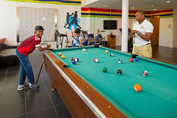 Im Jumeirah Beach Hotel spielen Gäste Billard im lebhaften Gemeinschaftsbereich.