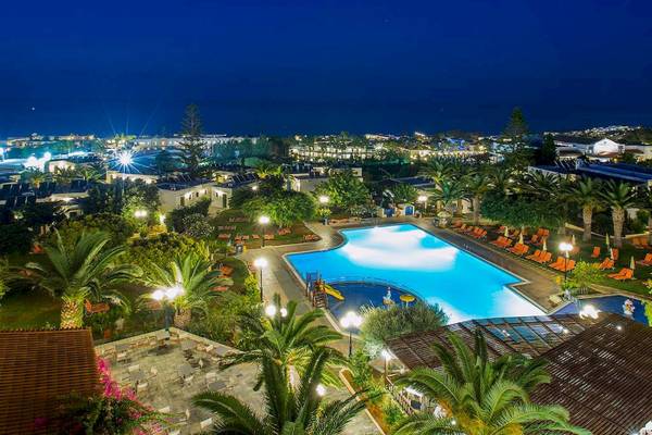 Abendliche Ansicht des Chrissi Amoudia Hotels mit Swimmingpool und Sonnenliegen