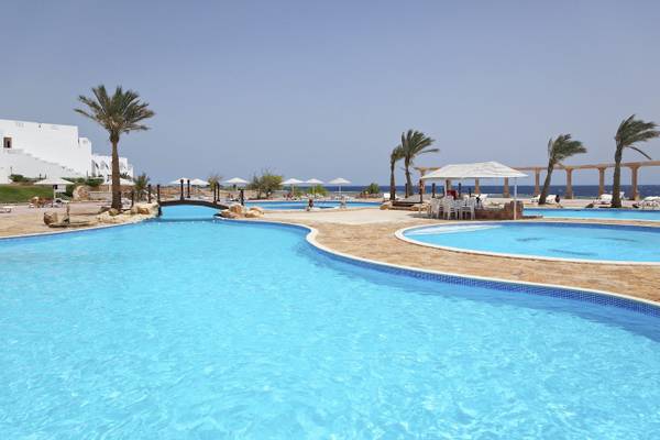 Außenpools des Three Corners Equinox Beach Resort mit Palmen und Sonnenschirmen