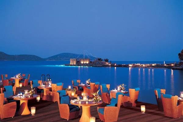 Elounda Beach Hotel & Villas Terrasse mit Blick auf den Ozean und eine Insel bei Nacht