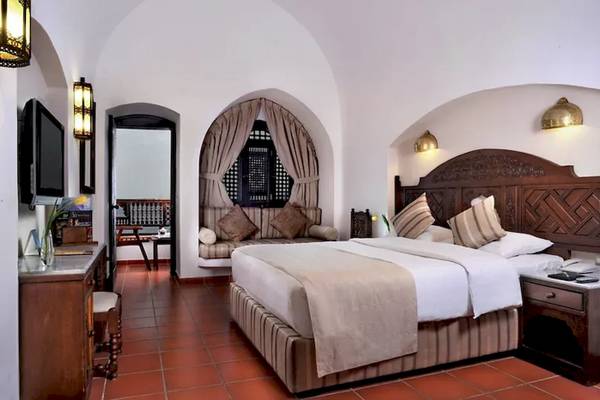Zimmer im Mövenpick Resort Sharm el Sheikh mit großem Bett, Sofa und Fernseher