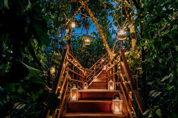 Beleuchtete Holztreppe des One & Only Reethi Rah Hotels im Dschungel