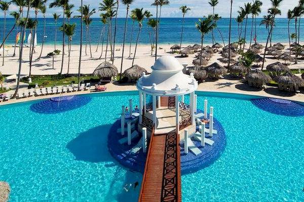 Luftaufnahme des Pools im Melia Caribe Beach Resort mit Sonnenschirmen und Palmen