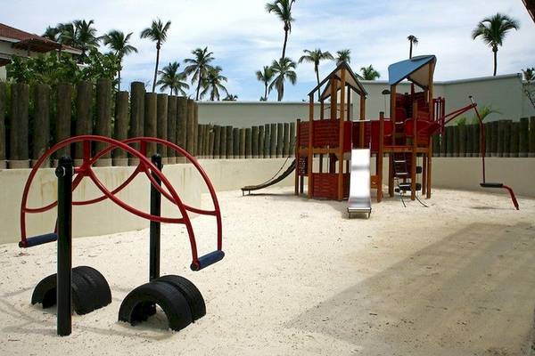 Spielplatz im Dreams Royal Beach Punta Cana Hotel mit Sandboden, Rutsche und Schaukeln
