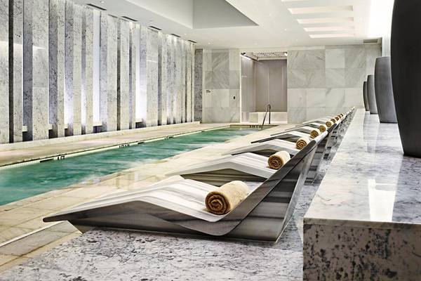 Innenpool im Fontainebleau Miami Beach mit Lounge-Liegen und Marmorwänden