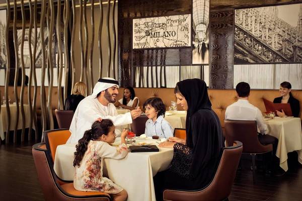 Familie genießt Mahlzeit im Conrad Abu Dhabi Etihad Towers Restaurant