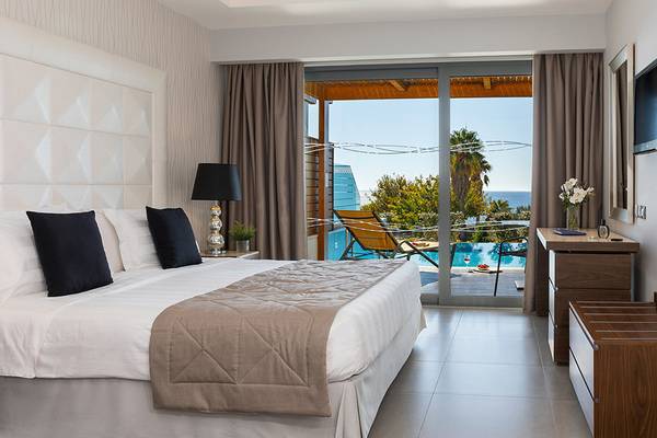 Boutique 5 Hotel & Spa Zimmer mit Poolblick, Bett, Lampen, Möbel und Panoramafenster.