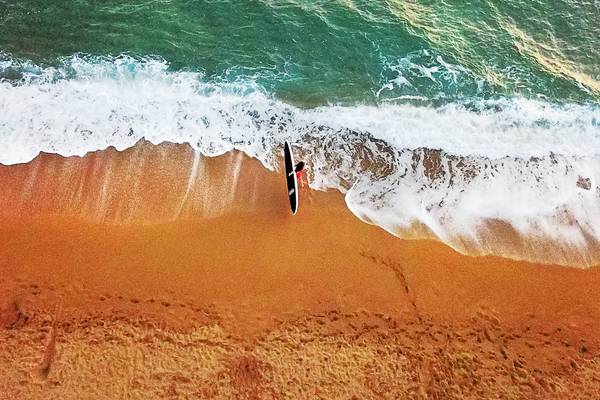 Luftaufnahme eines Strandes mit einem Surfer am Westin Resort, Costa Navarino.