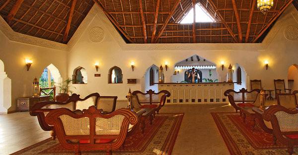 Innenbereich des Sultan Sands Island Resorts mit Möbeln, Teppichen und einer hohen Decke.