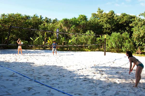 Beach-Volleyball-Spiel im Robinson Maldives mit Teilnehmern auf weißem Sand.