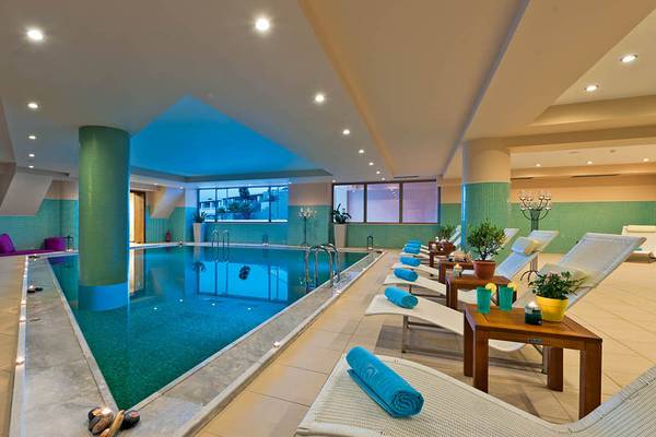 Innenpool des Giannoulis Cavo Spada Sports & Leisure Resorts mit Liegestühlen und Pflanzen.