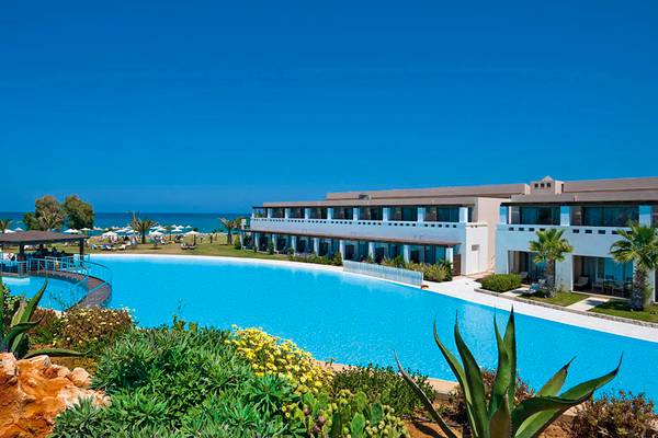 Außenansicht des Giannoulis Cavo Spada Sports & Leisure Resorts mit großem Pool und Blick auf das Meer.