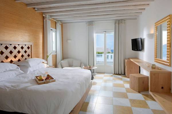 Schlafzimmer im Vencia Boutique Hotel mit einem Bett, einem Schreibtisch und einem Fernseher.